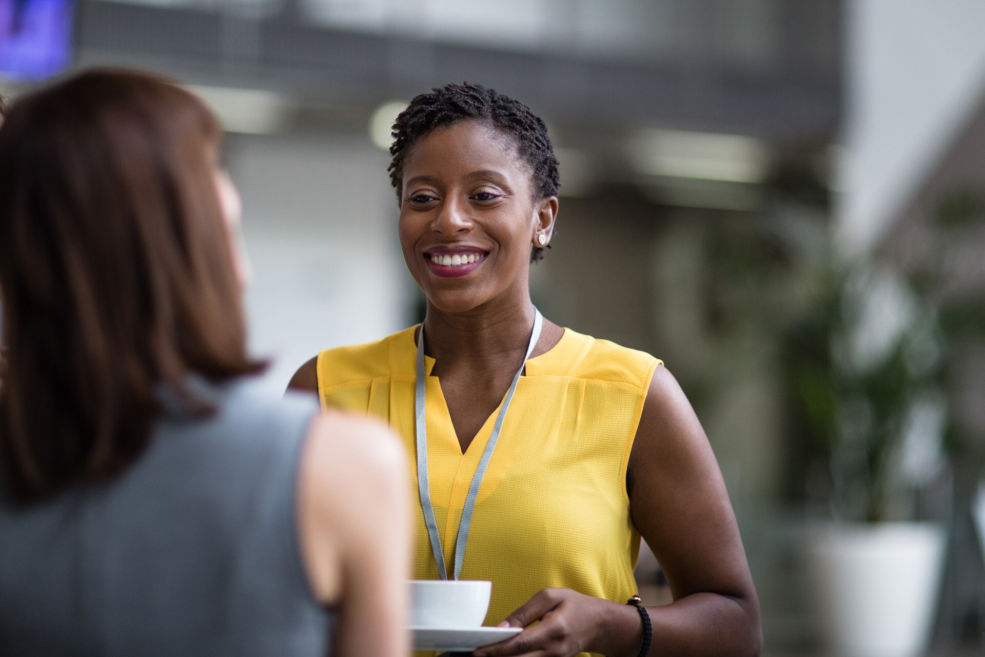 Two female business executives meeting at a networking event.