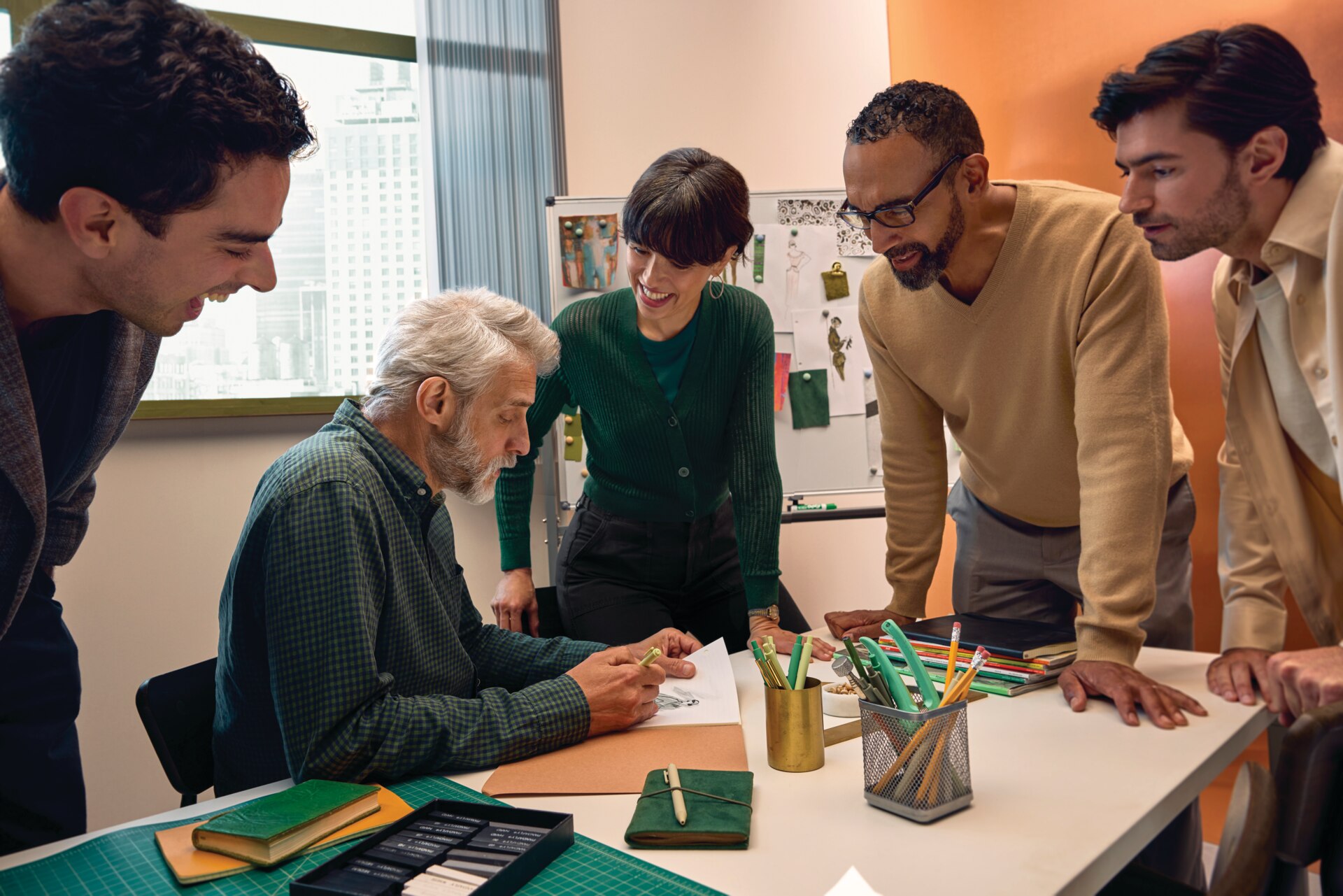 Group of people engaged in a conversation around a table, illustrating hearing and communicating in a busy group setting